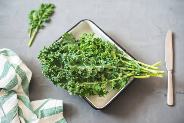 istock Green Organic healthy fresh Kale or leaf cabbage in a white enameled container 1211403069