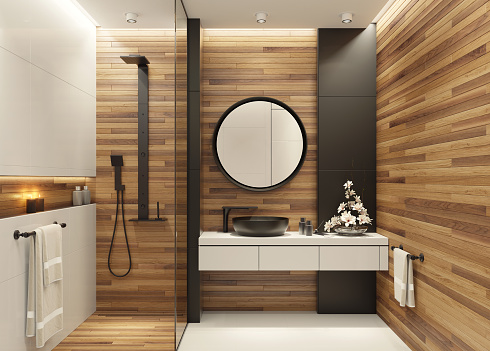 Luxurious bathroom with natural stone tiles and elegant round mirror.
Wood tiles on walls. Candle lens flare effect.