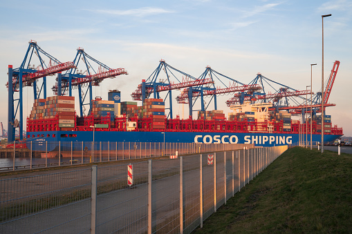 Hamburg, Germany - February 8, 2020: Container ship Cosco Shipping Leo in the port of Hamburg in early morning light on February 9, 2020 in Germany