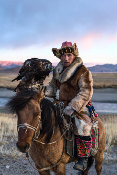 istock Portrait of eagle hunter on horse in steppe in Mongolia 1211405077