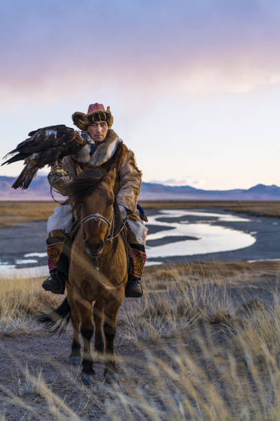 istock Portrait of eagle hunter on horse in steppe in Mongolia 1211405100