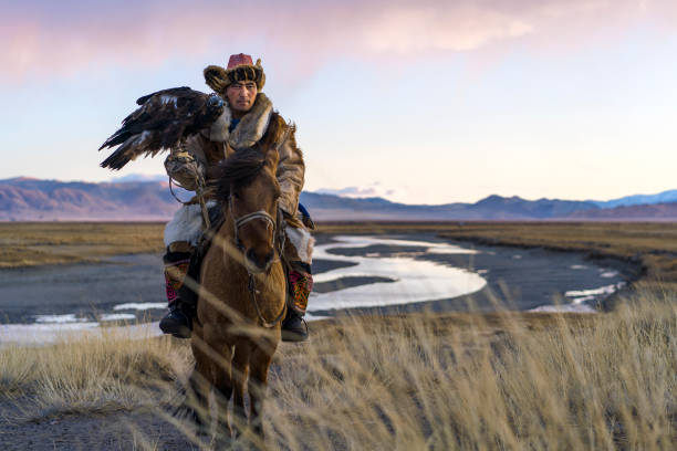 istock Portrait of eagle hunter on horse in steppe in Mongolia 1211405122