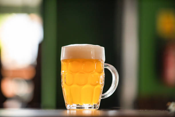 mug full of chopp, with chopp pilsen on a rustic table