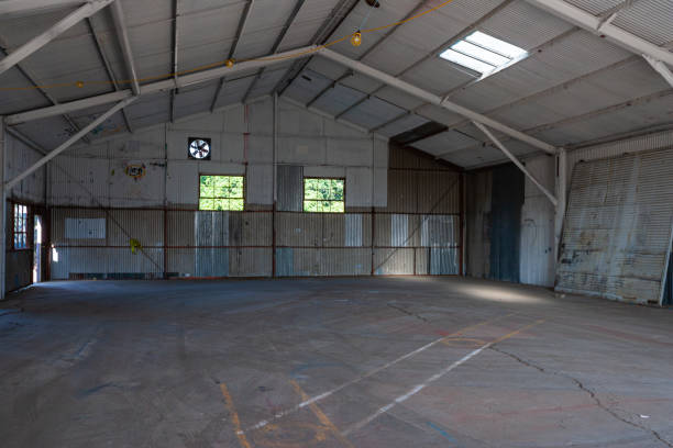 istock Empty warehouse with corrugated tin walls, steel construction and concrete floor 1211406516