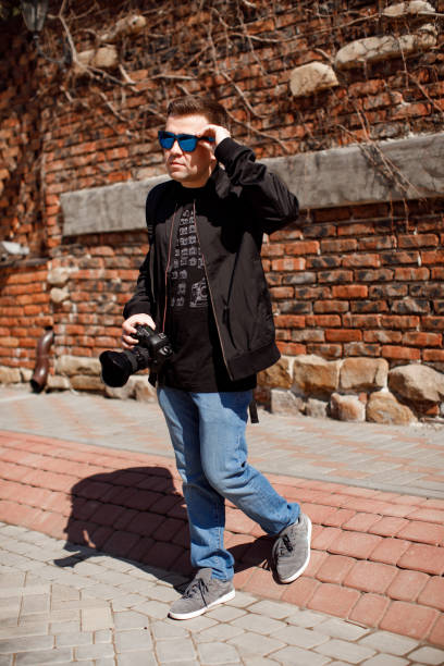 istock go photographer in black clothes and backpack 1211406746