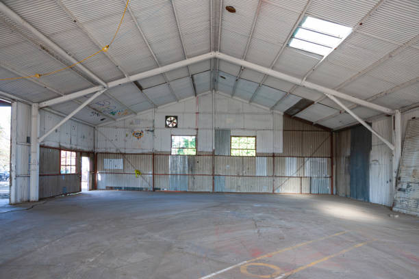 istock Empty warehouse with corrugated tin walls, steel construction and concrete floor 1211406772
