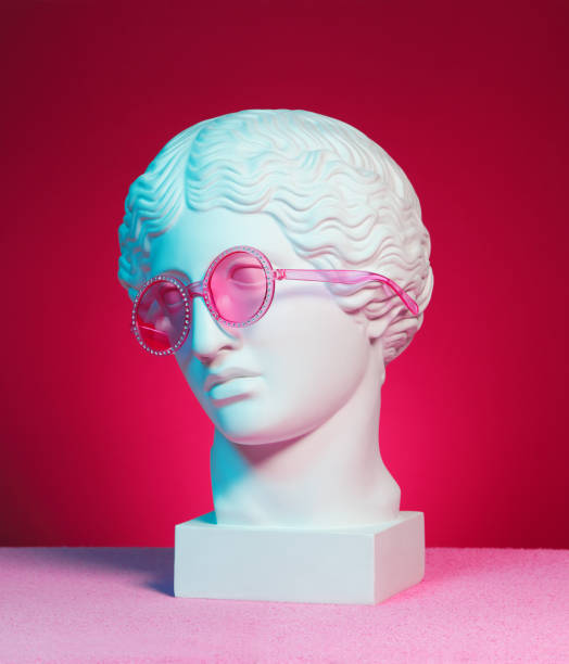 istock Plaster head sculpture with pink eyeglasses 1211407158