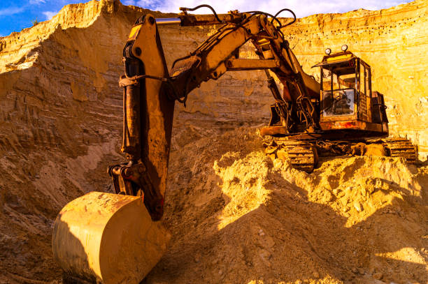 istock Sand mining concept - quarry sand excavator with heavy machinery - Construction industry - Old rusty bulldozer machine at break 1211407190