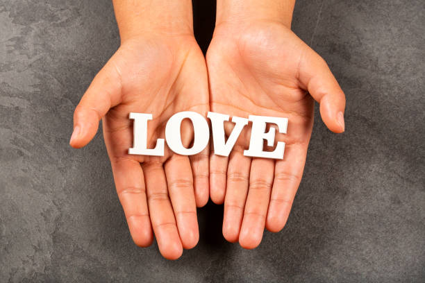 istock Hands holding the word love in letters 1211408148