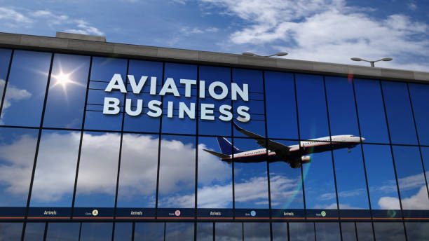 istock Airplane landing mirrored in terminal aviation business 1211410309