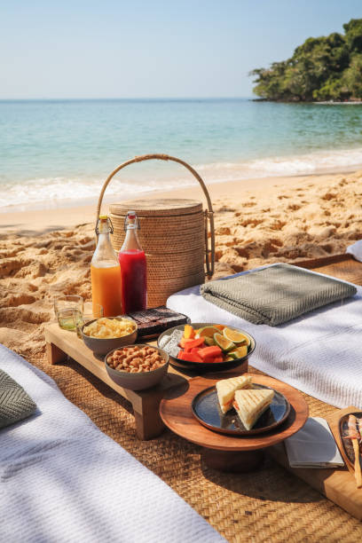 istock Beach Picnic by the sea with snacks and fruit and juice drinks 1211413161