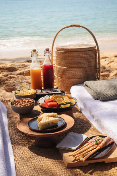 istock Beach Picnic by the sea with snacks and fruit and juice drinks 1211413166