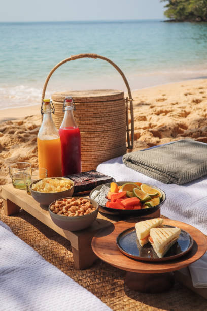 istock Beach Picnic by the sea with snacks and fruit and juice drinks 1211413173
