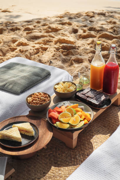 istock Beach Picnic by the sea with snacks and fruit and juice drinks 1211413177
