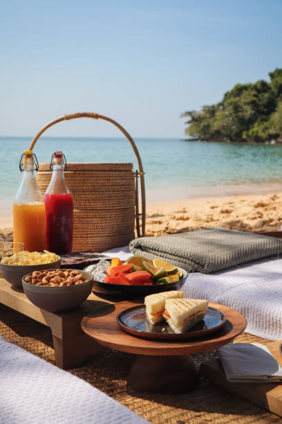 istock Beach Picnic by the sea with snacks and fruit and juice drinks 1211413188