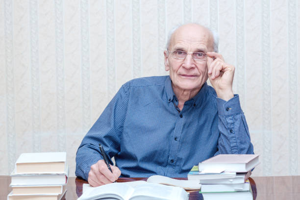 istock elderly professor with glasses in his hands 1211414923