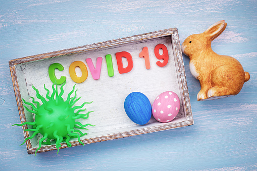 Corona virus COVID19 with Easter eggs and Bunny. Easter holiday plans cancelled concept