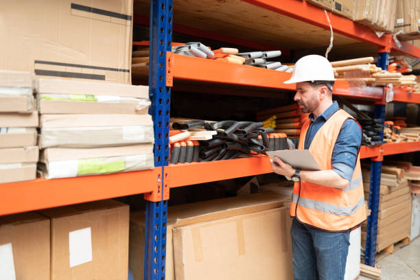 istock Confident Handsome Employee Checking Inventory At Factory 1211419218