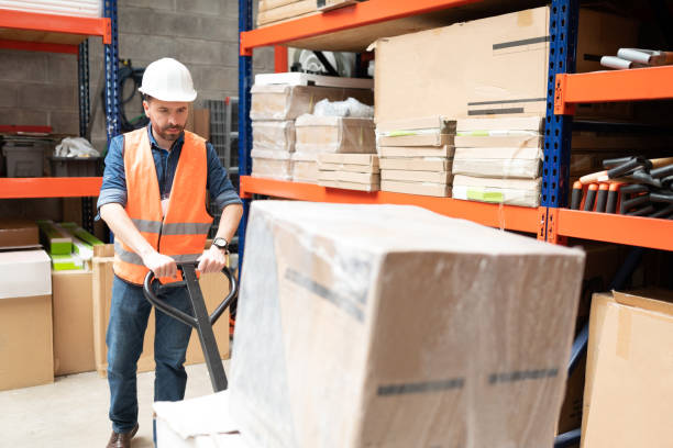 istock Employee Pushing Merchandise At Warehouse 1211421174
