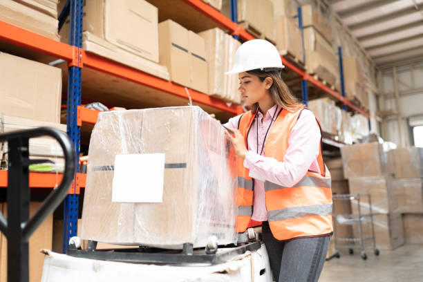istock Employee Wearing Helmet Working At Warehouse 1211421645