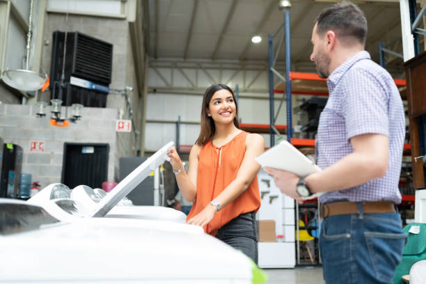 Female Customer Talking With Employee About Machine
