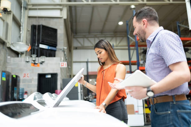 istock Male Employee Talking To Female Customer About Machine 1211422772