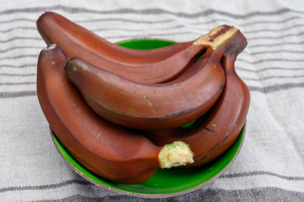 istock Bunch of ripe red bananas close up 1211422973