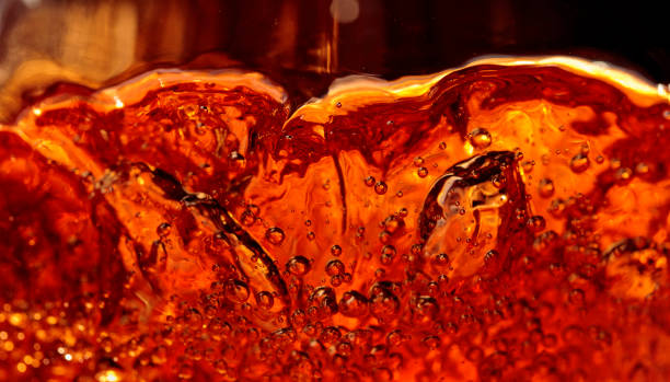 istock Alcoholic drink on a dark background, abstract splashing. 1211423424