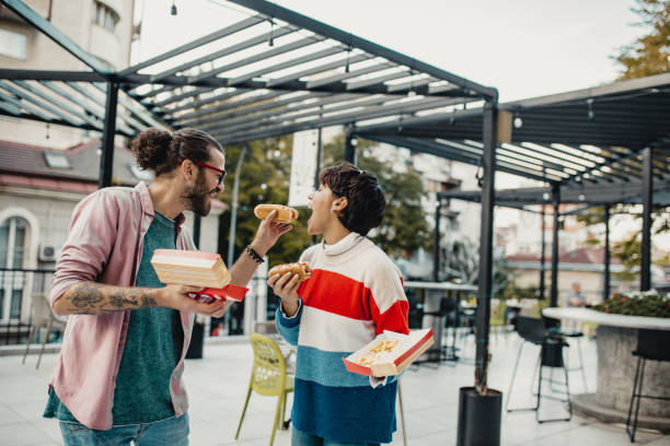 istock Couple eating fast food 1211423490