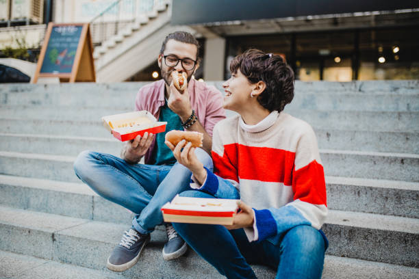 istock Couple eating fast food 1211423610
