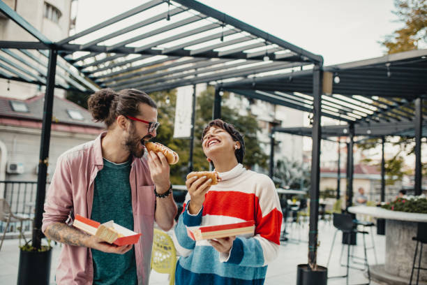 istock Couple eating fast food 1211423796