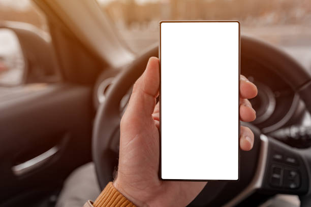istock Smartphone blank screen mock up in driver's hand 1211425218