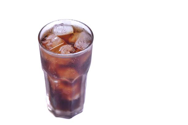 istock A cola glass with ice on white isolated background and copy space 1211428883