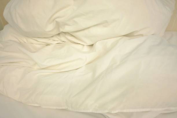 istock White crumpled bed sheet in the bed room 1211428994