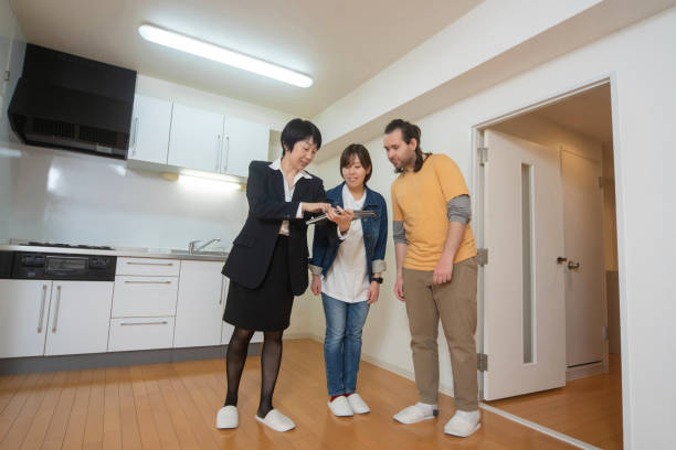 istock Real estate agent showing customers an apartment 1211436201