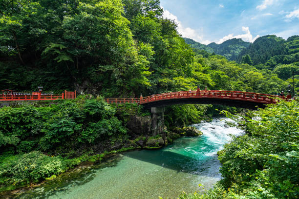 Shinkyo Bridge stands at the entrance to Nikko's shrines and temples, Japan View of the Shinkyo Bridge surrounded by a beautiful natural landscape. Nikko, Japan, August 2019 shinto photos stock pictures, royalty-free photos & images