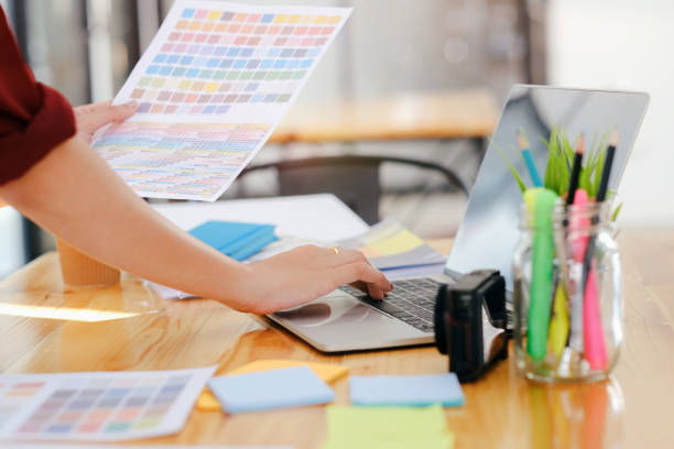 istock Young photographer and graphic designer at work in office. 1211439090
