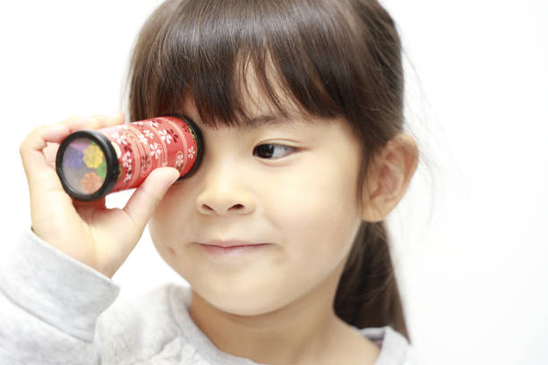 istock Japanese girl playing with kaleidoscope (white back) (5 years old) 1211440148