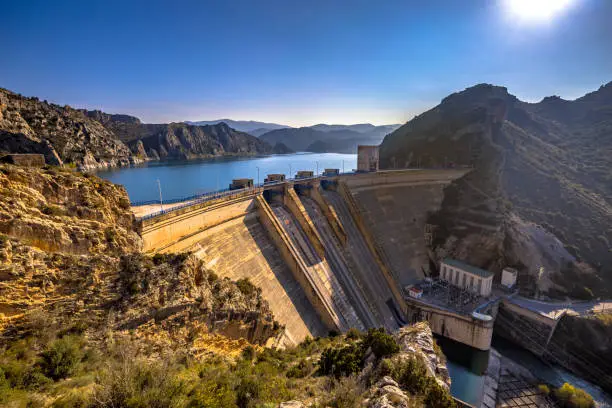 View of Hydroelectric dam at Embalse de Santa Ana reservoir lake in Sierras Exteriores, Spanish Pyrenees, Spain