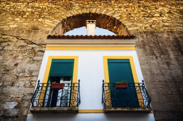 Houses in Evora (Alentejo, Portugal) along the ancient Agua da Prata aqueduct. Buildings were built during centuries directly between the arches of the aqueduct