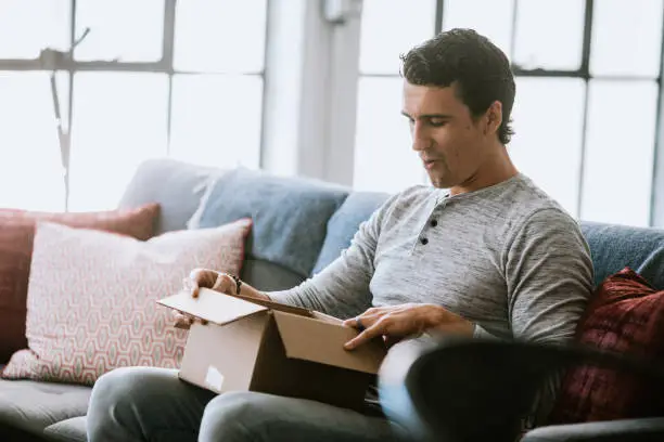 Photo of Excited Man Opens Package Delivery