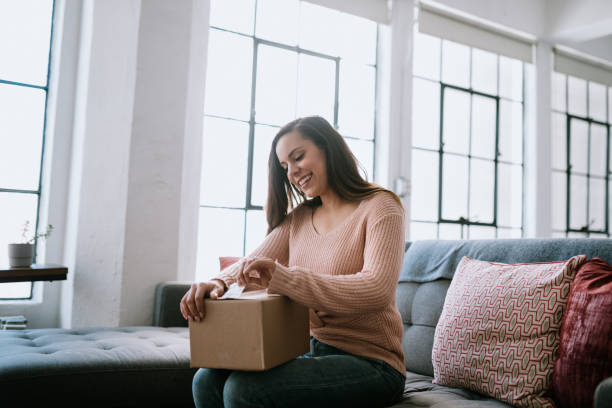 istock Excited Young Woman Opens Package Delivery 1211446488