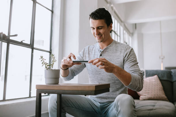 istock Man Makes Remote Online Deposit of Check 1211446575