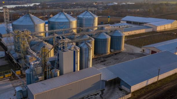 istock Large silver tanks of the elevator at the agro-industrial complex. 1211447375