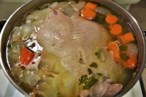istock Boiling Chicken in Pot with Vegetables to make chicken broth 1211447545