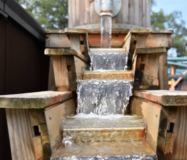 Barrel fountain with dropping steps representing clean water