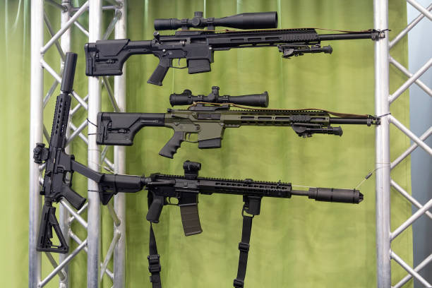 istock Automatic rifle hanging on the stand in the store. Weapon 1211449962