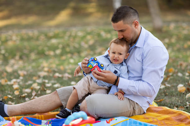 istock Father and son playing in park 1211450941