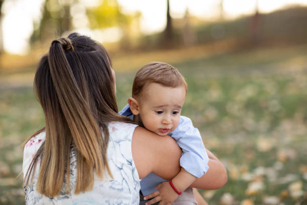 istock Young mother and baby boy walking in nature 1211451021