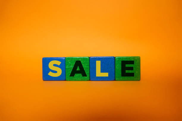 istock SALE, Wood Blocks on Orange Background. 1211453102